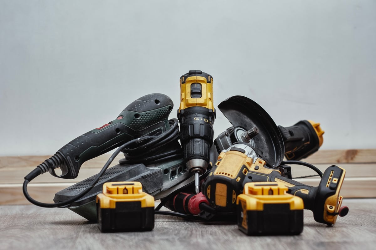 Power tools laid out on a wooden floor