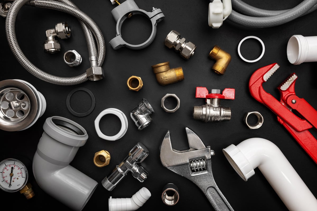 Plumbing tools on a dark background
